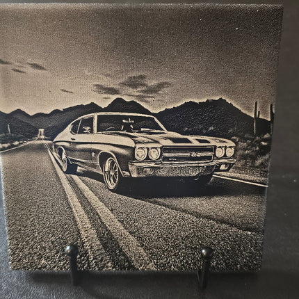Vintage car on a road with mountains in the background on a textured surface