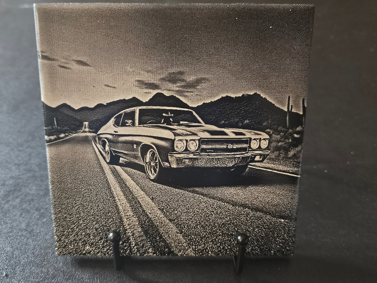 Vintage car on a road with mountains in the background on a textured surface