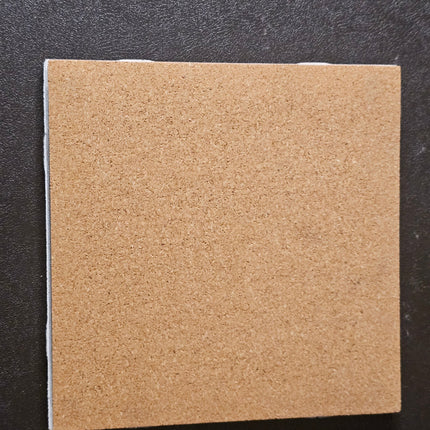 Square piece of cork on the back of a tile