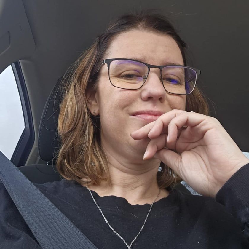 Melanie sitting inside her vehicle looking beautiful as always